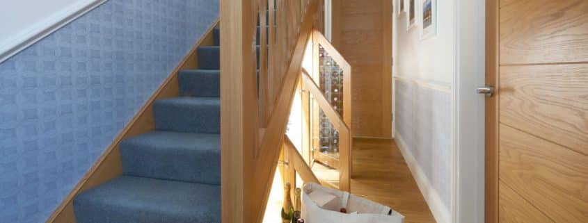 wine cellar under carpeted staircase