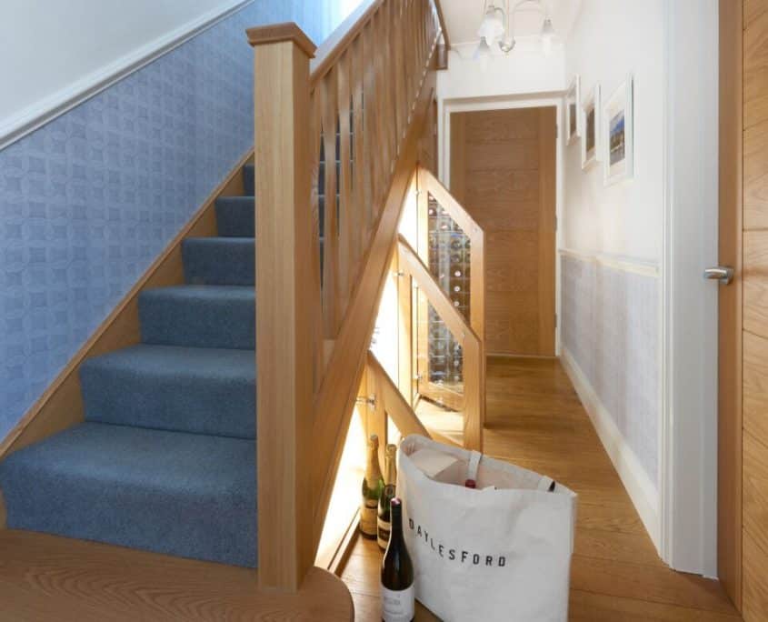 wine cellar under carpeted staircase