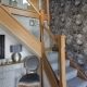 carpeted stairs with wooden glass railings