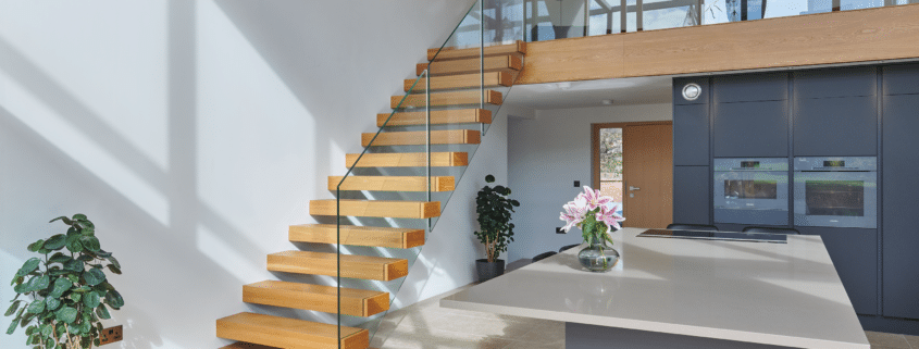 Modern interior with wooden stairs and plants.