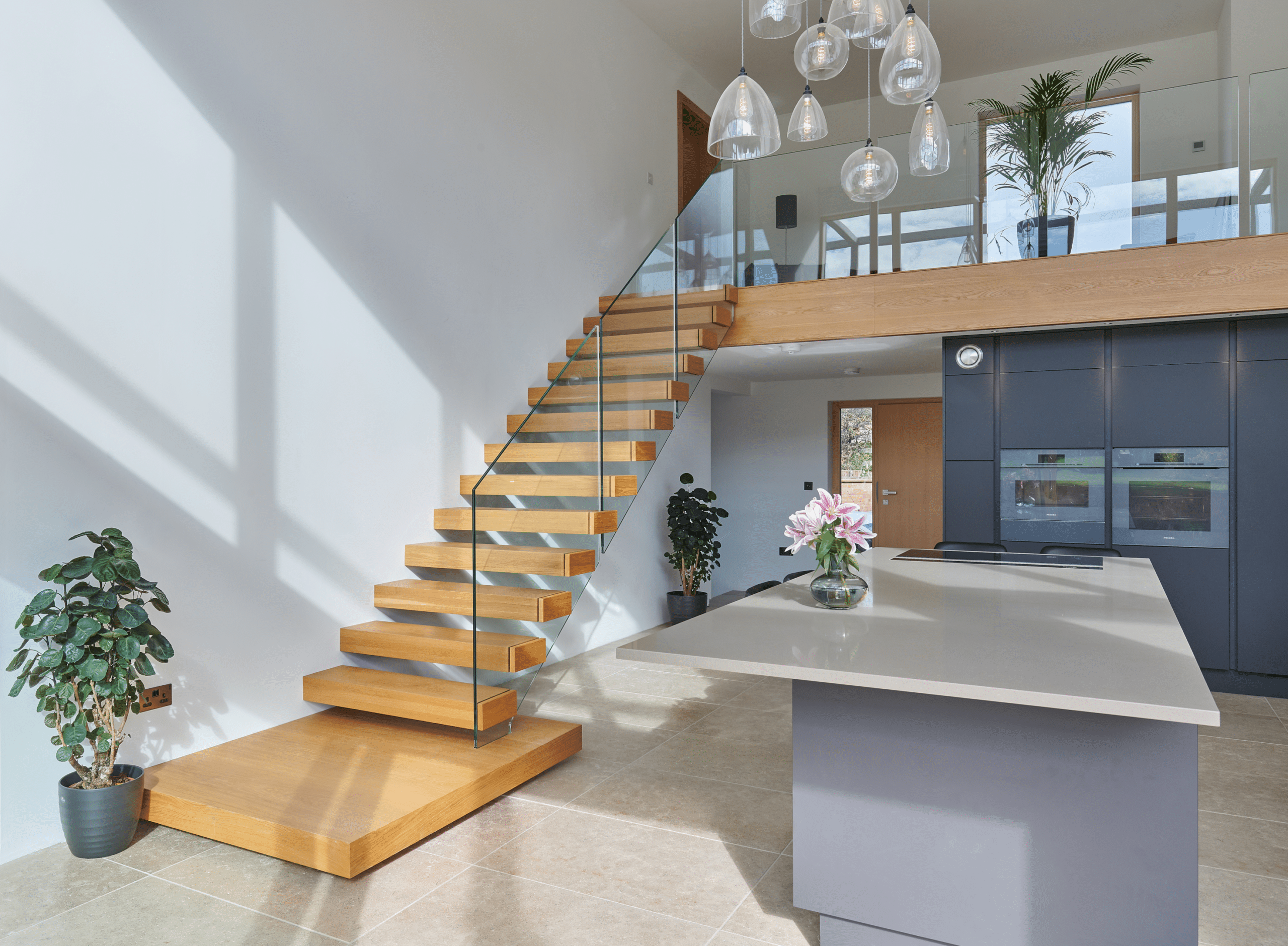 Modern interior with wooden stairs and plants.