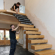 Trained installers fitting a floating staircase