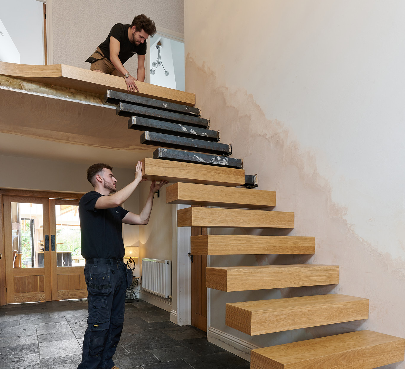 Trained installers fitting a floating staircase