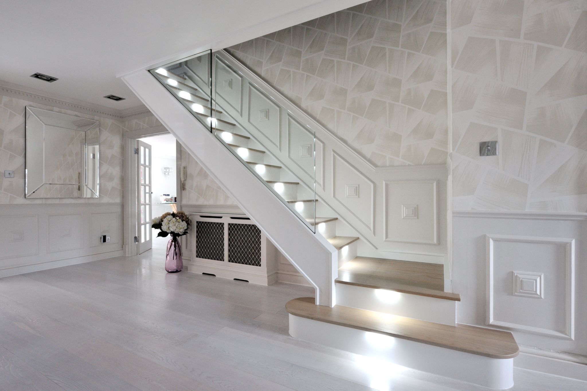 Glass Stairs modern glass staircase in a spacious room with white walls and wooden accents
